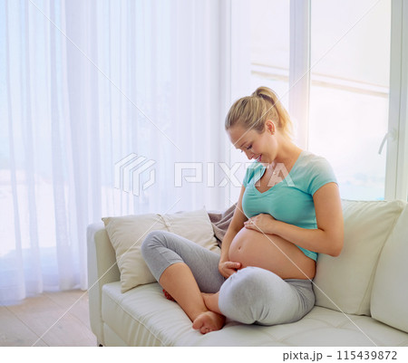 Mother, smile and pregnant woman on sofa in home holding belly for maternity care with happiness. Love, relaxing and maternal female person from Australia touch stomach in living room at apartment. Mother, smile and pregnant woman on sofa in home holding belly for maternity care with happiness. Love, relaxing and maternal female person from Australia touch stomach in living room at apartment. 115439872