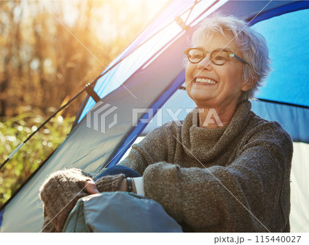 Camp, mature woman and vacation in tent, smile and outdoor to enjoy nature, freedom and sunshine. Retirement, hobby and morning at campsite, happy and healthy with wellness and relaxing natural view 115440027