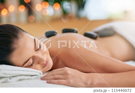 Back, hot stone for massage and woman in spa, on bed to relax for health, peace or wellness. Beauty, calm or wellbeing with client and skincare in clinic or salon for stress relief treatment Back, hot stone for massage and woman in spa, on bed to relax for health, peace or wellness. Beauty, calm or wellbeing with client and skincare in clinic or salon for stress relief treatment 115440072