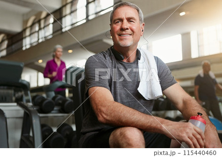 Fitness, thinking and senior man in gym with water bottle for training, exercise and workout. Sports, retirement and person with liquid, minerals and listening music for wellness, health and active 115440460