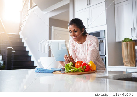 Tablet, ingredients and woman in kitchen for cooking with health, wellness and diet recipe. Smile, vegetables and Indian female person with digital technology for nutrition meal instructions at home. 115440570