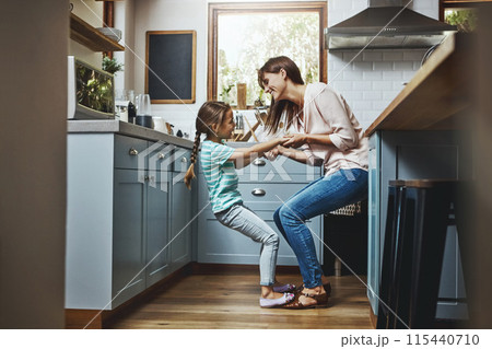 Happy, woman and child with playing in kitchen for cheerful fun, care and support on weekend. Smile, love and mom with little girl at family home for funny bonding, humor and joy in motherhood Happy, woman and child with playing in kitchen for cheerful fun, care and support on weekend. Smile, love and mom with little girl at family home for funny bonding, humor and joy in motherhood 115440710