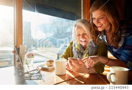 Mother, daughter and smartphone in cafe with coffee for social media, internet meme or bonding together. Date, senior lady and woman for networking, communication or online post in restaurant Mother, daughter and smartphone in cafe with coffee for social media, internet meme or bonding together. Date, senior lady and woman for networking, communication or online post in restaurant 115440943