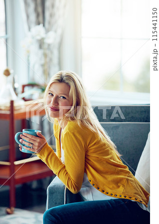 Happy, coffee and portrait of woman on sofa to relax, chill and calm with drink, beverage and cappuccino. Home, morning and person with cup, tea and mug in living room for wellness, rest and break 115441150