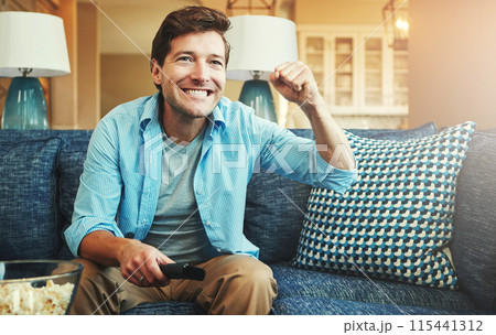 Happy, man and tv remote with popcorn in home on sofa on day off with watching sports game, challenge and fun. Living room, couch and excited or smile with fist for celebration, win and entertainment Happy, man and tv remote with popcorn in home on sofa on day off with watching sports game, challenge and fun. Living room, couch and excited or smile with fist for celebration, win and entertainment 115441312