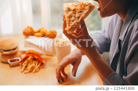 Cropped image of woman holding pizza slice at restaurant Cropped image of woman holding pizza slice at restaurant 115441800