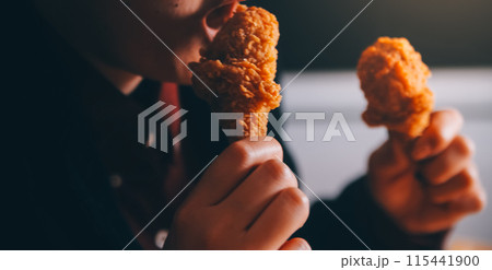 close up focus woman hand hold fried chicken for eat,girl with fast food concept close up focus woman hand hold fried chicken for eat,girl with fast food concept 115441900