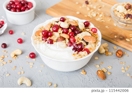 Healthy breakfast food with granola, yogurt, fruits and nuts. Dessert parfait with dried fruits for breakfast 115442006