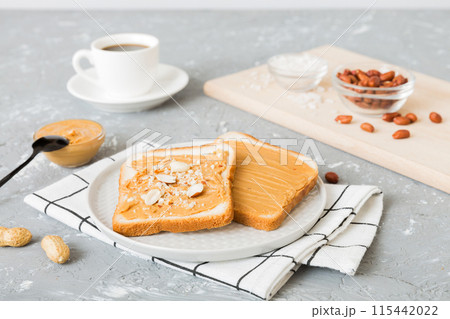 Peanut butter sandwiches or toasts on light table background.Breakfast. Vegetarian food. American cuisine top view vith copy space 115442022