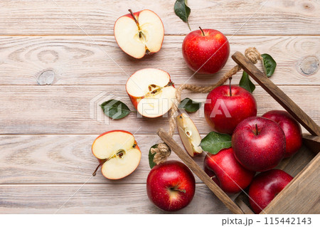 Ripe red apples in wooden box. On a white wooden background Ripe red apples in wooden box. On a white wooden background 115442143