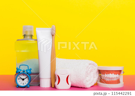 Mouthwash and other oral hygiene products on colored table top view with copy space. Flat lay. Dental hygiene. Oral care kit. Dentist concept 115442291