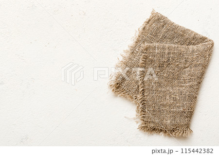 Old burlap fabric napkin, sackcloth on table background. top view with copy space 115442382