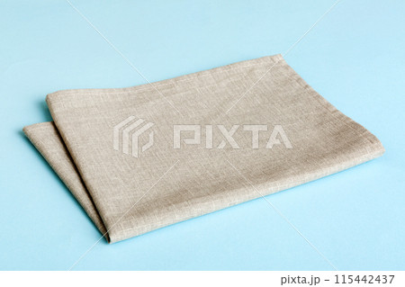 top view with gray kitchen napkin isolated on table background. Folded cloth for mockup with copy space, Flat lay. Minimal style top view with gray kitchen napkin isolated on table background. Folded cloth for mockup with copy space, Flat lay. Minimal style 115442437