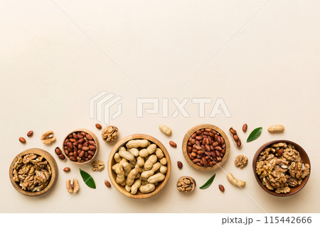 Walnut kernel halves, in a wooden bowl. Close-up, from above on colored background. Healthy eating Walnut concept. Super foods with copy space 115442666
