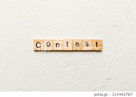 Contest word written on wood block. Contest text on cement table for your desing, Top view concept 115442767