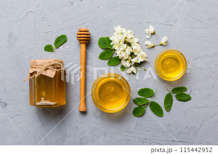 honey jar with acacia flowers and leaves. fresh honey top view flat lay honey jar with acacia flowers and leaves. fresh honey top view flat lay 115442952