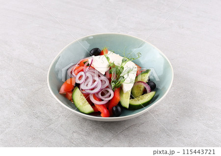 Salad with cheese and fresh vegetables isolated on white background. Greek salad. Salad with cheese and fresh vegetables isolated on white background. Greek salad. 115443721