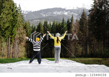 Children celebrating in snowy mountain forest Children celebrating in snowy mountain forest 115444159