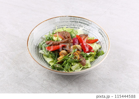 Beef steak salad with cherry tomatoes, cucumbers, red onions, romaine salad and lime mustard olive oil salad dressing Beef steak salad with cherry tomatoes, cucumbers, red onions, romaine salad and lime mustard olive oil salad dressing 115444588
