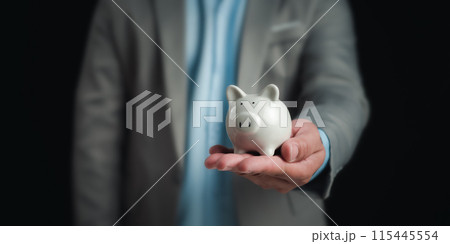Businessman holding the white piggy bank for saving money concept, Money saving concept, Save for investment, banking, loan, home loan, Financial planning, education and healthy insurance. 115445554