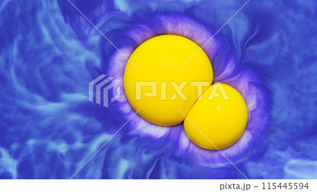 Top view of macro abstract photography of the yellow droplet acrylic on gradient blue background Top view of macro abstract photography of the yellow droplet acrylic on gradient blue background 115445594