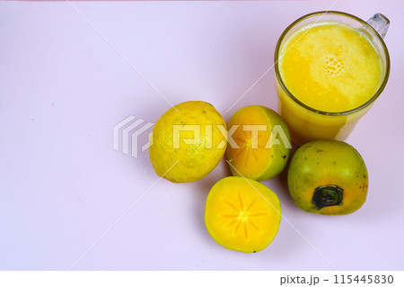 a glass of persimmon lemonade. Persimmon lemonade is a refreshing drink. a glass of persimmon lemonade. Persimmon lemonade is a refreshing drink. 115445830