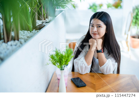 modern portrait of beautiful happy asian woman traveler wearing smartwatch wearing beautiful white dress and wear jeans lifestyle enjoying in sitting coffee shop restaurant background modern portrait of beautiful happy asian woman traveler wearing smartwatch wearing beautiful white dress and wear jeans lifestyle enjoying in sitting coffee shop restaurant background 115447274