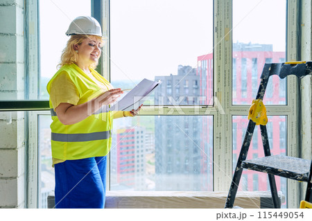 Technical profession woman in protective vest helmet working on construction Technical profession woman in protective vest helmet working on construction 115449054