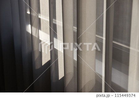 Window curtain detail with sunlight 115449374