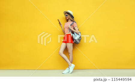 Summer vacation, tourism, happy traveler young woman tourist holding phone in hat with backpack Summer vacation, tourism, happy traveler young woman tourist holding phone in hat with backpack 115449594