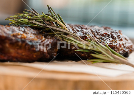Pork steak with sauce on a wooden board Pork steak with sauce on a wooden board 115450566