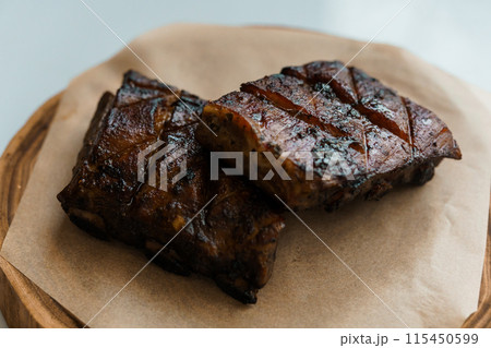 Pork steak with sauce on a wooden board 115450599