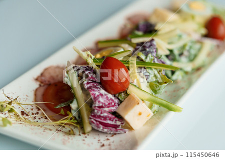 Salad with herbs hard cheese black olives cherry tomatoes onion cucumber Salad with herbs hard cheese black olives cherry tomatoes onion cucumber 115450646