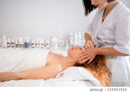 Relaxed young woman receiving spa treatment in 115451910