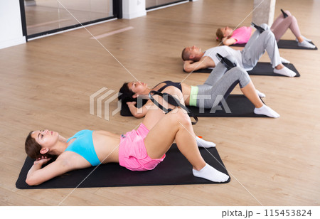 Group of adults exercising with pilates ring Group of adults exercising with pilates ring 115453824