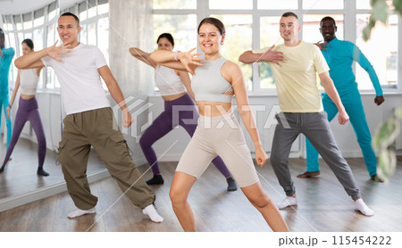 European girl with team of like-minded multinational people learn to elements of electro dance European girl with team of like-minded multinational people learn to elements of electro dance 115454222
