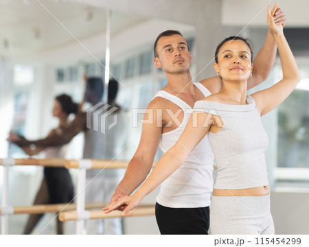 Young man and young woman rehearsing pair ballet Young man and young woman rehearsing pair ballet 115454299