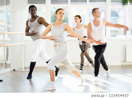 Asian woman enjoying ballet practice with group of amateurs 115454437