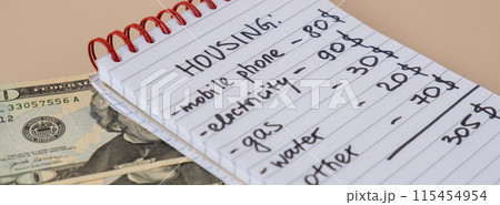 Counting expenses bills on housing electricity, gas, water. Banknotes of dollar cash around. High prices for energy inflation crisis. Cut back on spending 115454954