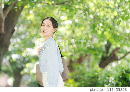 新緑の中を歩くビジネスウーマン 新緑の中を歩くビジネスウーマン 115455898
