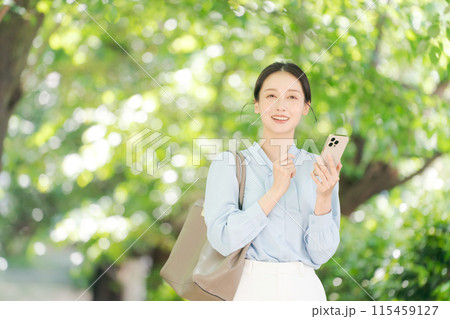 公園でスマホを持つビジネスウーマン 公園でスマホを持つビジネスウーマン 115459127