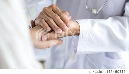 The female doctor uses a friendly hand to hold the patient's hand to give confidence and show care about health care. Medical concepts and good health 115460513