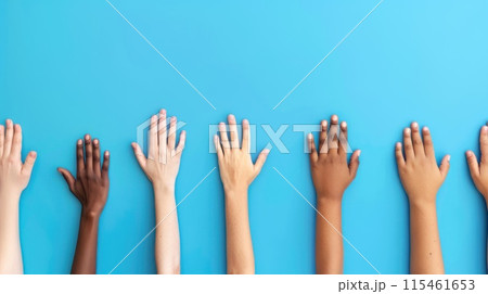 Colorful cut out paper hands of different skin colors reaching up on a blue background. 115461653