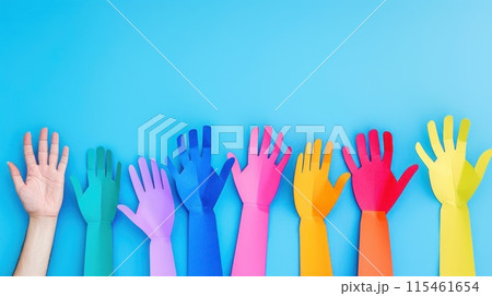 Colorful cut out paper hands of different skin colors reaching up on a blue background. 115461654