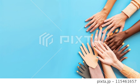 Colorful cut out paper hands of different skin colors reaching up on a blue background. 115461657
