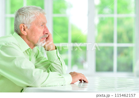 close-up portrait of a senior man thinking about something close-up portrait of a senior man thinking about something 115462157