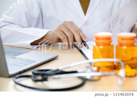 The female doctor sat and checked the patient's history and used a laptop to record patient information at the hospital. Medical concepts and interests 115463059