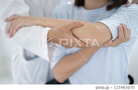 Female physiotherapists provide physical assistance to women patients with elbow injuries examine patients in rehabilitation centers. Physiotherapy concepts 115463070