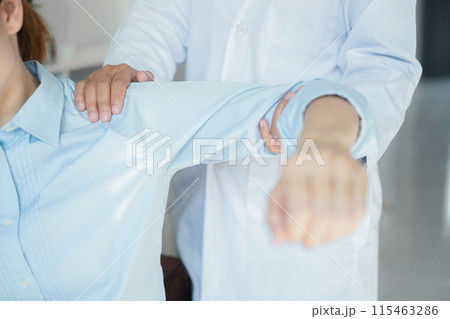 Female physiotherapists provide physical assistance to patients with shoulder injuries massaging their shoulders for muscle recovery in the rehabilitation center. Physiotherapy concepts 115463286