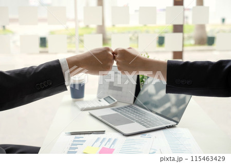 Two business leaders talk about charts, financial graphs showing results are analyzing and calculating planning strategies, business success building processes, and shake hands 115463429